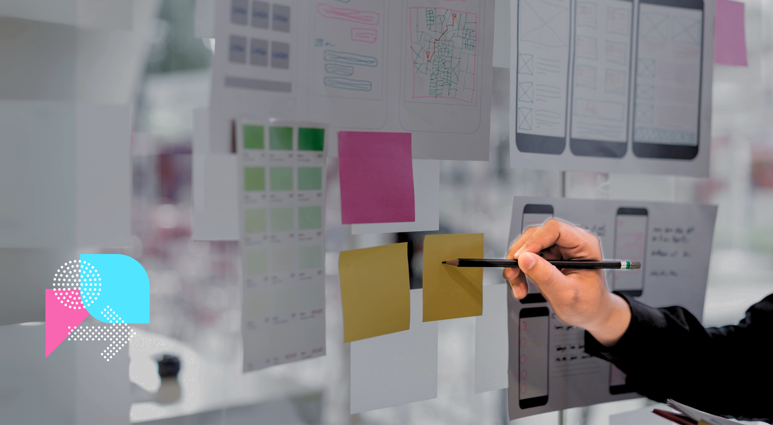 Person pointing at post it notes on a board. Working on UX design.