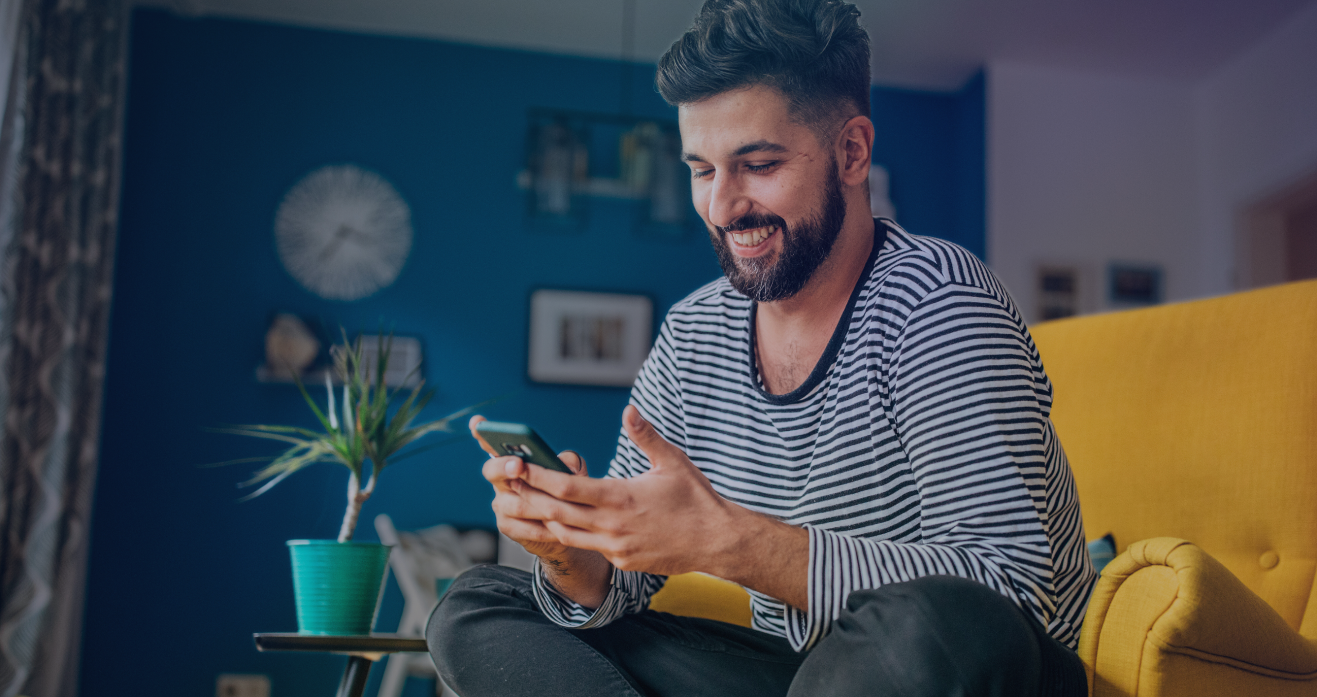 Person using a mobile whilst sat in a chair.
