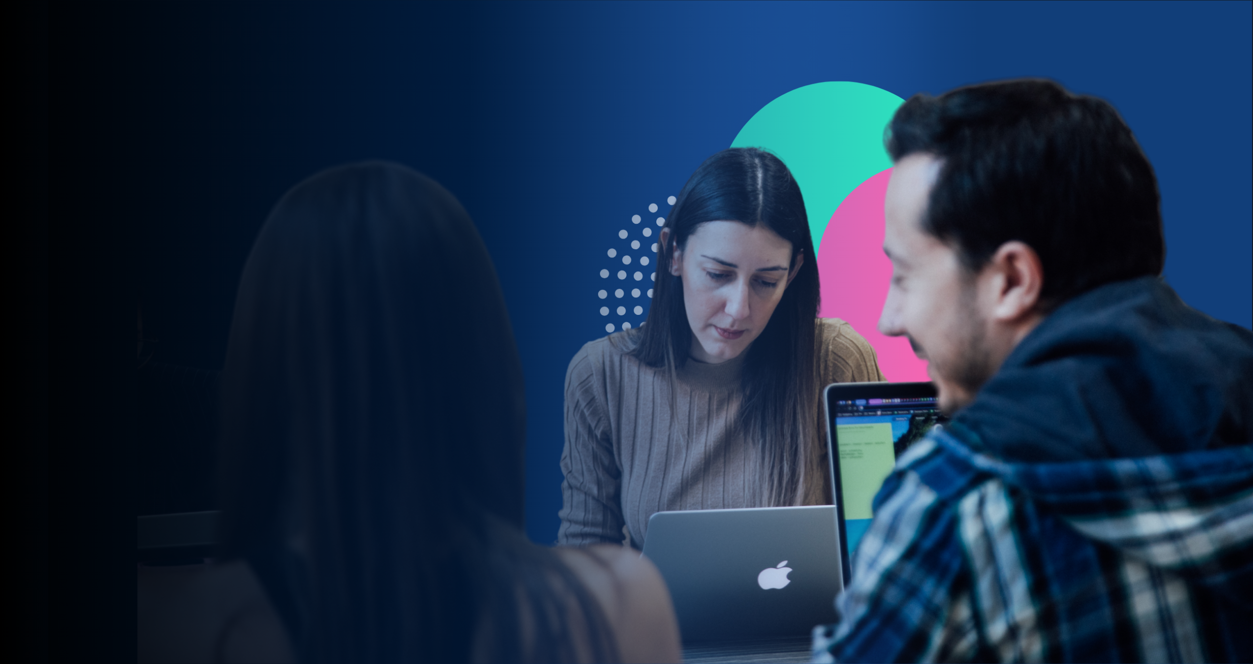 people working together with their laptops open in front of them