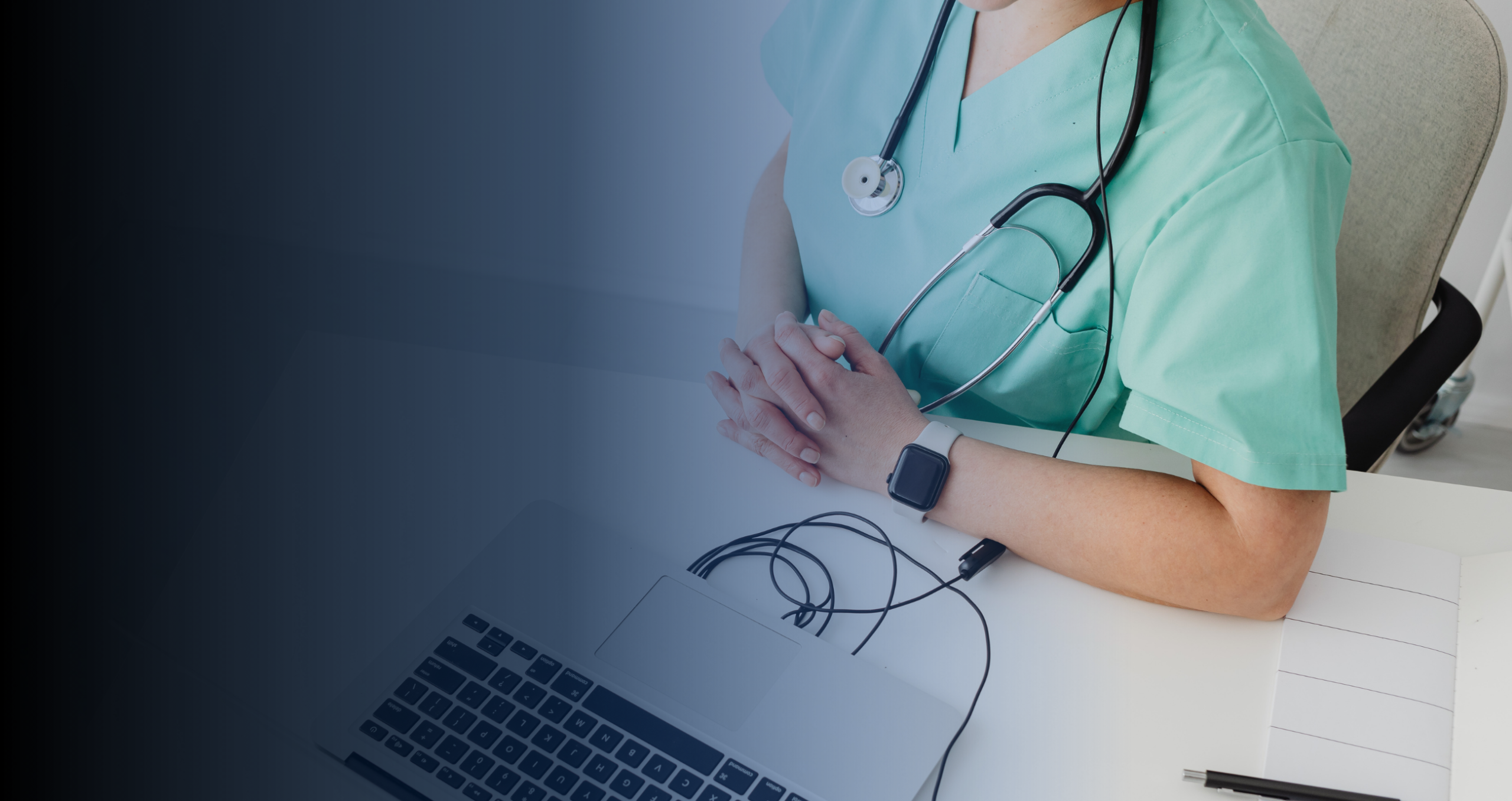 a health professional sitting in front of a computer as seen from the top